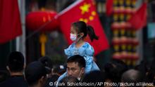 07.10.2022
FILE - A girl wearing a face mask rides on a man's shoulders as they walk along a tourist shopping street in Beijing on Oct. 7, 2022. China has announced its first overall population decline in recent years amid an aging society and plunging birthrate. (AP Photo/Mark Schiefelbein, File)