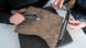 Researchers inspect a runestone found at Tyrifjorden, Norway, at the Museum of Cultural History in Oslo, Thursday, Jan. 12, 2023. Researchers inspect a runestone found at Tyrifjorden, Norway, at the Museum of Cultural History in Oslo, Thursday, Jan. 12, 2023.