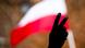 A hand makes the peace sign in front of a Polish flag during a protest to express support for and solidarity with judge Igor Tuleya, Krakow, Poland, June 6, 2020 A hand makes the peace sign in front of a Polish flag during a protest to express support for and solidarity with judge Igor Tuleya, Krakow, Poland, June 6, 2020