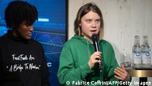 Sweden's activist Greta Thunberg (R) speaks next to Ugandan climate justice activist Vanessa Nakate (L) during a session with International Energy Agency chief on the sideline of the World Economic Forum (WEF) annual meeting in Davos, on January 19, 2023. - Thunberg accused attendees of the World Economic Forum in Davos of fuelling the destruction of the planet as she arrived at the event in the Swiss Alps. (Photo by Fabrice COFFRINI / AFP) / The erroneous mention[s] appearing in the metadata of this photo by Fabrice COFFRINI has been modified in AFP systems in the following manner: [Ugandan climate justice activist Vanessa Nakate] added. Please immediately remove the erroneous mention[s] from all your online services and delete it (them) from your servers. If you have been authorized by AFP to distribute it (them) to third parties, please ensure that the same actions are carried out by them. Failure to promptly comply with these instructions will entail liability on your part for any continued or post notification usage. Therefore we thank you very much for all your attention and prompt action. We are sorry for the inconvenience this notification may cause and remain at your disposal for any further information you may require. (Photo by FABRICE COFFRINI/AFP via Getty Images)