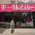 A person walks by a T-Mobile store in New York City