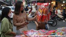 (230115) -- HANOI, Jan. 15, 2023 (Xinhua) -- People select products with cat element at a market at Hang Ma street in Hanoi, capital of Vietnam, Jan. 14, 2023. As the Lunar New Year approaches, products featuring the image of cat are popping up in the market of Hang Ma street in Hanoi. Cat is the zodiac animal of the upcoming Lunar New Year in Vietnam. (Xinhua/Hu Jiali)