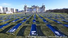 BERLIN, GERMANY - JANUARY 19: A view of camp beds with photographs of people who severely affected by Covid-19 placed at the Bundestag in Berlin on January 19, 202. Camp beds symbolize people suffering from long-term health effects of Covid-19. Abdulhamid Hosbas / Anadolu Agency