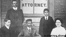 Mohandas K. Gandhi, center seated, is surrounded by workers in his law office in Johannesburg, South Africa, in 1902. Gandhi, the country's first lawyer who is a person of color to be admitted to the bar, spent most of his 20 years in South Africa protesting the treatment of Indians by the British. The others in the photo are not identified. (AP Photo)