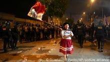 A woman waves a Peruvian flag during an anti-government protest in Lima, Peru, Friday, Jan. 20, 2023. Protesters are seeking the resignation of President Dina Boluarte, the release from prison of ousted President Pedro Castillo and immediate elections. (AP Photo/Guadalupe Pardo)