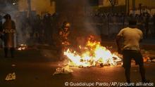 Police clear a street during anti-government protests in Lima, Peru, Friday, Jan. 20, 2023. Protesters are seeking the resignation of President Dina Boluarte, the release from prison of ousted President Pedro Castillo and immediate elections. (AP Photo/Guadalupe Pardo)