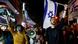 Protesters carying Israeli flags and posters on the streets of Tel Aviv Protesters carying Israeli flags and posters on the streets of Tel Aviv