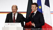 French President Emmanuel Macron, right, and German Chancellor Olaf Scholz leave after a joint press conference, Sunday, Jan. 22, 2023 at the Elysee Palace in Paris. France and Germany are seeking to overcome differences laid bare by Russia's war in Ukraine and shore up their alliance with a day of ceremonies and talks Sunday on Europe's security, energy and other challenges. (Benoit Tessier, Pool via AP)