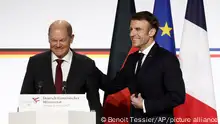 French President Emmanuel Macron, right, and German Chancellor Olaf Scholz leave after a joint press conference, Sunday, Jan. 22, 2023 at the Elysee Palace in Paris. France and Germany are seeking to overcome differences laid bare by Russia's war in Ukraine and shore up their alliance with a day of ceremonies and talks Sunday on Europe's security, energy and other challenges. (Benoit Tessier, Pool via AP)