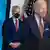 Jeff Zients standing behind Joe Biden while wearing a mask