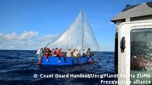 September 25, 2022, Caribbean Sea, Cayman Islands: A Coast Guard law enforcement crew stops a homemade sailboat carrying Cuban migrants attempting to flee the ongoing political instability ahead of Hurricane Ian, September 25, 2022 near the Cayman Islands. (Credit Image: Â© Coast Guard Handout/Uscg/Planet Pix via ZUMA Press Wire