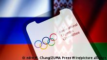 February 28, 2022, Asuncion, Paraguay: Illustration: In-camera multiple exposure image shows logo of the International Olympic Committee (IOC), on smartphone backdropped by displayed cropped waving flags of Russia and Belarus. (Credit Image: Â© Andre M. Chang/ZUMA Press Wire