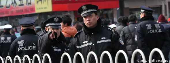 epa02604601 A policeman guarding the entrance to Wangfujing street points to a photographer in central Beijing, China, on 27 February 2011. Police barred foreign reporters from the site of a planned anti-government protest in Beijing 27 February amid the tightest security in the Chinese capital since the 2008 Olympic Games. Scores of uniformed and plain-clothes police moved people away from the area around a fast food restaurant in the nearby Wangfujing shopping street where activists called for weekly protests each Sunday afternoon. EPA/HOW HWEE YOUNG +++(c) dpa - Bildfunk+++ ### usage Germany only, Verwendung nur in Deutschland ###