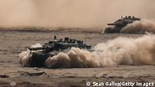 ZAGAN, POLAND - JUNE 12: Leopard 2 main battle tanks of the Bundeswehr, the German armed forces, take part in the NATO Noble Jump military exercises during a live fire demonstration on June 12, 2019 in Zagan, Poland. The exercises include VJTF, or Very High Readiness Joint Task Force, units, as well as the I German-Netherlands Corps, with soldiers from Germany, the Netherlands, Norway and Poland taking part. (Photo by Sean Gallup/Getty Images)