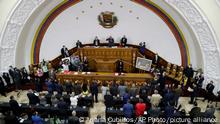 National Assembly President Jorge Rodriguez, top center, swears in Venezuela's new National Electoral Council directors, during an extraordinary session at the National Assembly in Caracas, Venezuela, Tuesday, May 4, 2021. The National Assembly, with an overwhelming pro-government majority, on Tuesday appointed two recognized opponents as members of the new board of the National Electoral Council of Venezuela. (AP Photo/Ariana Cubillos)