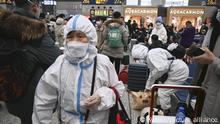 Travelers in protective gear await the departure of trains at Shanghai Hongqiao railway station on Jan. 20, 2023, as the Lunar New Year holidays start the following day in China where COVID-19 is spreading widely. (Kyodo)
