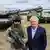 Глава концерна Rheinmetall Армин Паппергер рядом с "пехотинцем будущего" и новейшим танком Panther