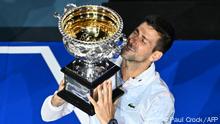 Serbia's Novak Djokovic celebrates with the Norman Brookes Challenge Cup trophy following his victory against Greece's Stefanos Tsitsipas in the men's singles final match on day fourteen of the Australian Open tennis tournament in Melbourne on January 29, 2023. (Photo by Paul CROCK / AFP) / -- IMAGE RESTRICTED TO EDITORIAL USE - STRICTLY NO COMMERCIAL USE --