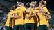 Members of the Australia team celebrate a goal in a huddle, image from an April 12, 2022 friendly against New Zealand. Members of the Australia team celebrate a goal in a huddle, image from an April 12, 2022 friendly against New Zealand.