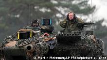 01.02.2023 *** German Defense Minister Boris Pistorius, right, sits on a Leopard 2 tank at the Bundeswehr tank battalion 203 at the Field Marshal Rommel Barracks in Augustdorf, Germany, Wednesday, Feb. 1, 2023. After the government's decision to deliver fourteen Leopard 2 tanks to Ukraine, the capabilities of the Leopard 2A6 main battle tank are shown at a presentation in Augustdorf. (AP Photo/Martin Meissner)