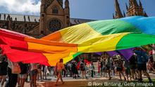 02.02.2023+++ SYDNEY, AUSTRALIA - FEBRUARY 02: Protesters hold a giant rainbow flag outside St Mary's Cathedral ahead of the pontifical requiem Mass for Cardinal George Pell on February 02, 2023 in Sydney, Australia. Cardinal George Pell, a former senior Catholic Church official who was accused of sexual violence in Australia and then cleared, died on 10 January 2023 aged 81 years old. His body was returned to Sydney after his funeral at the Vatican and will lie in state at St. Mary's Cathedral on Feb. 1 and 2. (Photo by Roni Bintang/Getty Images)