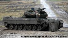 A Leopard 2 tank is seen in action during a visit of German Defense Minister Boris Pistorius at the Bundeswehr tank battalion 203 at the Field Marshal Rommel Barracks in Augustdorf, Germany, Wednesday, Feb. 1, 2023. After the government's decision to deliver fourteen Leopard 2 tanks to Ukraine, the capabilities of the Leopard 2A6 main battle tank are shown at a presentation in Augustdorf. (AP Photo/Martin Meissner)
