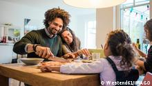Happy family having lunch together on dining table at home model released, Symbolfoto property released, MOEF04432