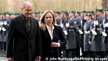 German Chancellor Olaf Scholz (L) and Italys Prime Minister Giorgia Meloni review an honor guard during a welcoming ceremony in front of the Chancellery in Berlin on February 3, 2023. (Photo by John MACDOUGALL / AFP) (Photo by JOHN MACDOUGALL/AFP via Getty Images)