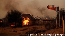 Flames consume a house during a fire in Santa Juana, Concepcion province, Chile on February 3, 2023. - Chile has declared a state of disaster in several central-southern regions after a devastating heat wave provoked forest fires that left four people dead, authorities said on Friday. (Photo by JAVIER TORRES / AFP) (Photo by JAVIER TORRES/AFP via Getty Images)