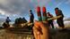 Person holdign fingers painted in Libyan colors, while children play on tank in Benghazi Person holdign fingers painted in Libyan colors, while children play on tank in Benghazi