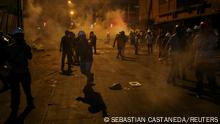Demonstrators are surrounded by smoke during an anti-government protest following the ouster of Peru's former President Pedro Castillo, in Lima, Peru February 4, 2023. REUTERS/Sebastian Castaneda 