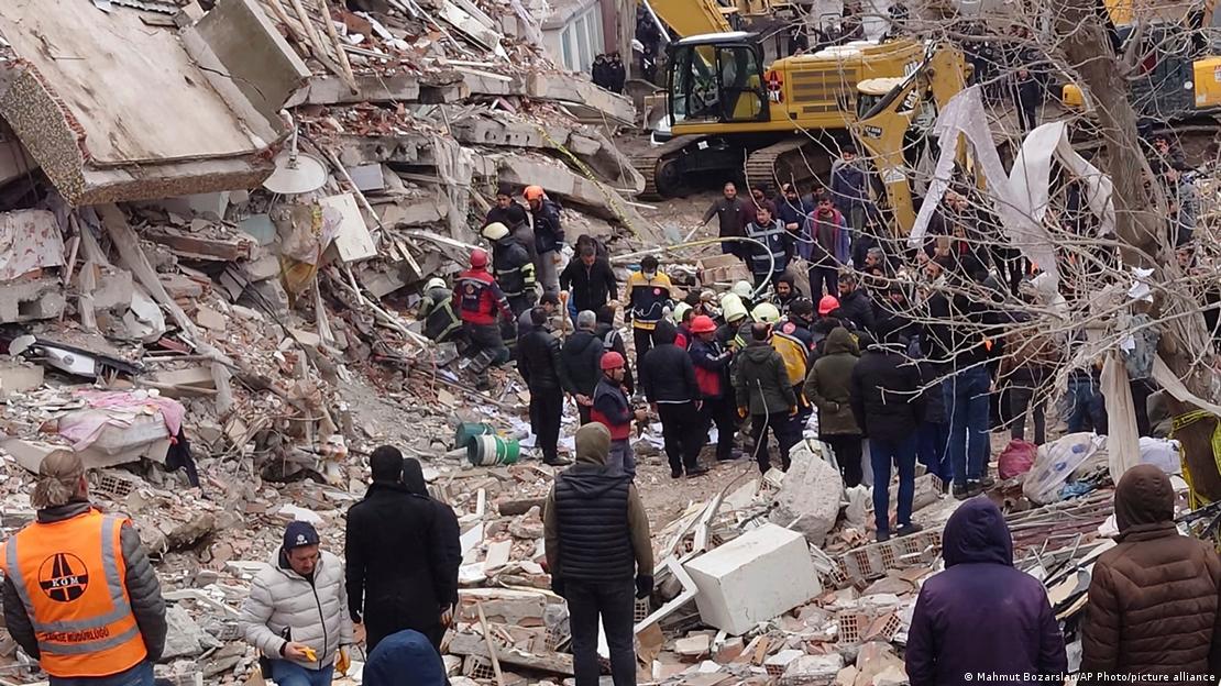 Rescue workers search for survivors amid the rubble of a collapsed building 