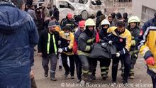 Firefighters carry the body of a victim in Diyarbakir, in southeastern Turkey, Monday, Feb. 6, 2023. A powerful earthquake that struck southeast Turkey and northern Syria has killed more than 640 people with hundreds injured. The toll is expected to rise as rescuers search for dead and survivors in dozens of collapsed buildings across the region. (AP Photo/Mahmut Bozarsan)