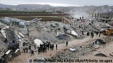 This aerial view shows residents helped by bulldozers, searching for victims and survivors in the rubble of collapsed buildings, following an earthquake in the town of Sarmada in the countryside of the northwestern Syrian Idlib province, early on February 6, 2023. - A 7.8-magnitude earthquake hit Turkey and Syria on February 6, killing hundreds of people as they slept, levelling buildings, and sending tremors that were felt as far away as the island of Cyprus and Egypt. (Photo by MUHAMMAD HAJ KADOUR / AFP) (Photo by MUHAMMAD HAJ KADOUR/AFP via Getty Images)