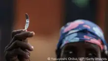 TOPSHOT - Ex-female genital mutilation (FGM) cutter Monika Cheptilak, who stopped practicing after the country set anti-FGM law in 2010, shows a homemade tool from a nail used for FGM, during the meeting of anti-FGM women group in Alakas village, bordering with Kenya, northeast Uganda on January 31, 2018. - The UN estimates that over 200 million girls and women have experienced FGM which is a life-threatening procedure that involves the partial or total removal of a woman's external genitalia. February 6, 2018, marks the 6th International Day of Zero Tolerance for FGM. (Photo by Yasuyoshi CHIBA / AFP) (Photo by YASUYOSHI CHIBA/AFP via Getty Images)