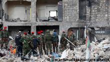 Russian soldiers and Syrian security forces inspect the wreckage of collapsed buildings, in Aleppo, Syria, Tuesday, Feb. 7, 2023. Rescuers raced Tuesday to find survivors in the rubble of thousands of buildings brought down by a powerful earthquake and multiple aftershocks that struck eastern Turkey and neighboring Syria. (AP Photo/Omar Sanadiki)