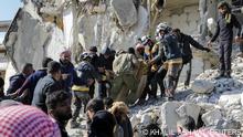 Rescuers carry a victim on the rubble as the search for survivors continues in the aftermath of an earthquake, in rebel-held town of Jandaris, Syria February 7, 2023. REUTERS/Khalil Ashawi
