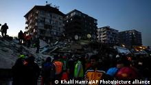 Rescue teams search for people in the rubble of destroyed buildings in Antakya, southern Turkey, Wednesday, Feb. 8, 2023. With the hope of finding survivors fading, stretched rescue teams in Turkey and Syria searched Wednesday for signs of life in the rubble of thousands of buildings toppled by a catastrophic earthquake. (AP Photo/Khalil Hamra)