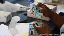 12/01/2023 An official of the Independent National Electoral Commission (INEC) sorts out Permanent Voters card (PVC) of voters at a ward in Lagos on January 12, 2023 ahead of February 25 presidential election. (Photo by PIUS UTOMI EKPEI / AFP)
