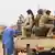 Des soldats de la Coordination des mouvements de l'Azawad assis à l'arrière d'un pik-up.