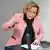 Beatrix von Storch speaking in front of microphones wearing a pink jacket in the Bundestag