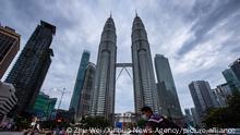 (210112) -- KUALA LUMPUR, Jan. 12, 2021 (Xinhua) -- A cyclist wearing a face mask waits for traffic light in front of the Petronas Twin Towers in Kuala Lumpur, Malaysia, Jan. 12, 2021. Malaysia reported 3,309 new COVID-19 infections in the highest daily spike since the outbreak, bringing the national total to 141,533, the Health Ministry said on Tuesday. (Xinhua/Zhu Wei)