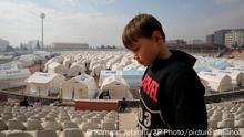 A child walks at a stadium where tents have been setup to accommodate earthquake survivors, in Kharamanmaras, southeastern Turkey, Friday, Feb. 10, 2023. Rescuers pulled several people alive from the shattered remnants of buildings on Friday, some who survived more than 100 hours trapped under crushed concrete in the bitter cold after a catastrophic earthquake slammed Turkey and Syria. (AP Photo/Kamran Jebreili)