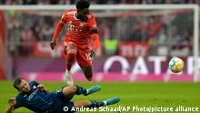Bayern's Alphonso Davies, top, duels for the ball with Bochum's Kevin Stoeger during the Bundesliga soccer match between Bayern Munich and VfL Bochum 1848 at the Allianz Arena in Munich, Germany, Saturday, Feb.11, 2023. (AP Photo/Andreas Schaad)