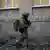 Ukrainian soldier walks along building in Bakhmut