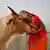 A woman worships a cow as Indian Hindus offer prayers to the River Ganges