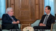 In this photo released on the official Facebook page of the Syrian Presidency, Syrian President Bashar Assad meets with Martin Griffiths, United Nations Under-Secretary-General for Humanitarian Affairs, left, in Damascus, Syria, Monday, Feb. 13, 2023. Griffiths also met with Syrian Foreign Minister Faisal Mekdad Monday to discuss ways to get aid to all parts of Syria following the deadly earthquake that hit Turkey and Syria last week. (Syrian Presidency Facebook page via AP)