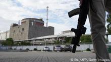 TOPSHOT - This photo taken on September 11, 2022 shows a security person standing in front of the Zaporizhzhia Nuclear Power Plant in Enerhodar (Energodar), Zaporizhzhia Oblast, amid the ongoing Russian military action in Ukraine. - The Zaporizhzhia Nuclear Power Station in southeastern Ukraine is the largest nuclear power plant in Europe and among the 10 largest in the world. (Photo by STRINGER / AFP) (Photo by STRINGER/AFP via Getty Images)