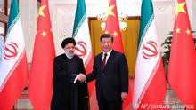 In this photo released by the official website of the office of the Iranian Presidency, President Ebrahim Raisi, left, shakes hands with his Chinese counterpart Xi Jinping in an official welcoming ceremony in Beijing, Tuesday, Feb. 14, 2023. (Iranian Presidency Office via AP)