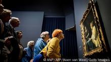 Visitors look at the painting Mistress and Maid during the opening of the Johannes Vermeer exhibition in the Rijksmuseum in Amsterdam on February 9, 2023. - Guests from all over the Netherlands who have a link with the name Vermeer have been invited to the opening. The exhibition contains 28 of the 37 works made by Johannes Vermeer. - Netherlands OUT (Photo by Koen van Weel / ANP / AFP) / Netherlands OUT (Photo by KOEN VAN WEEL/ANP/AFP via Getty Images)